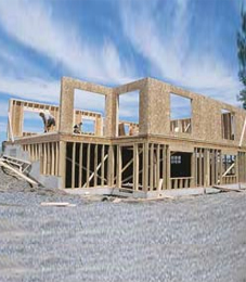 A two–storey building site that shows a range of hazards including materials on the ground and scaffolding.