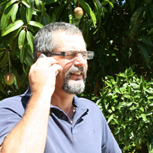 Pat Miller the builder talking on the phone to his client.